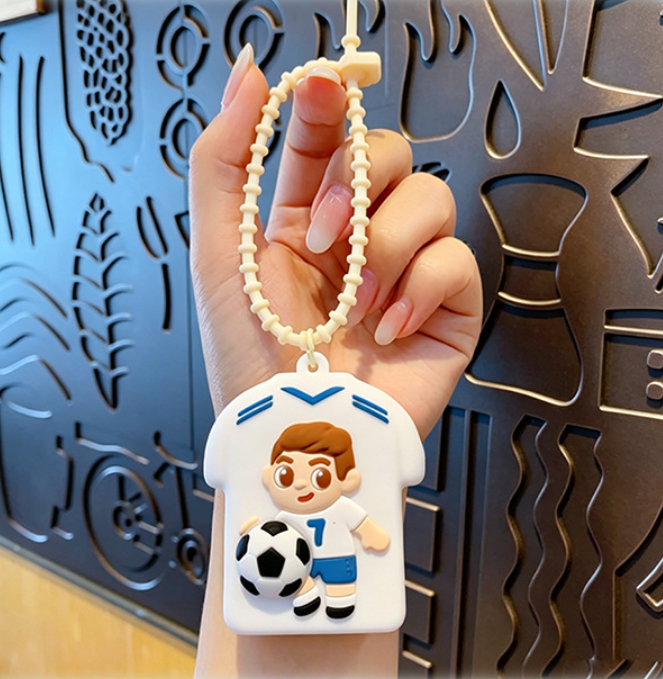 💥 BUY 2 GET 2 FREE + 💞50K+ SOLD!💥⚽Cute Football Player Squishy Keychain, Silicone Stress Relief Toy, Soccer Jersey Bag Charm for Kids & Adults